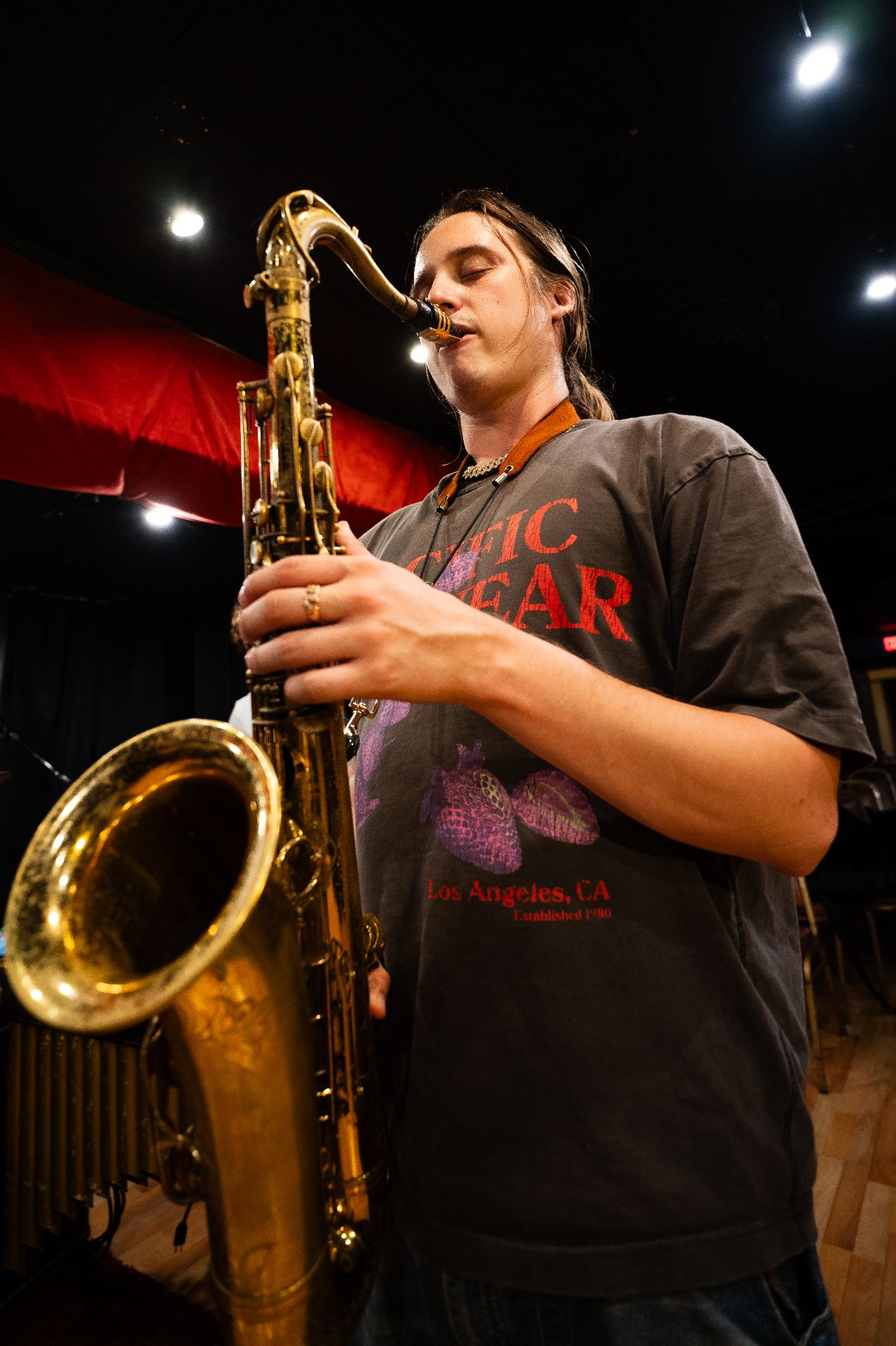 Low-angle tenor sax under stage lights